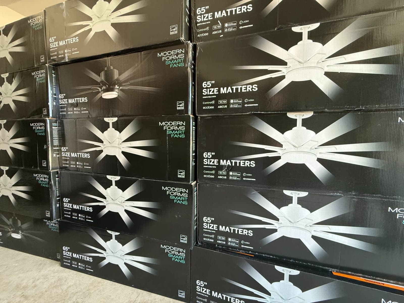 Stacked boxes of Modern Forms 65 inch Size Matters smart fans in the Lighting Source TX shop